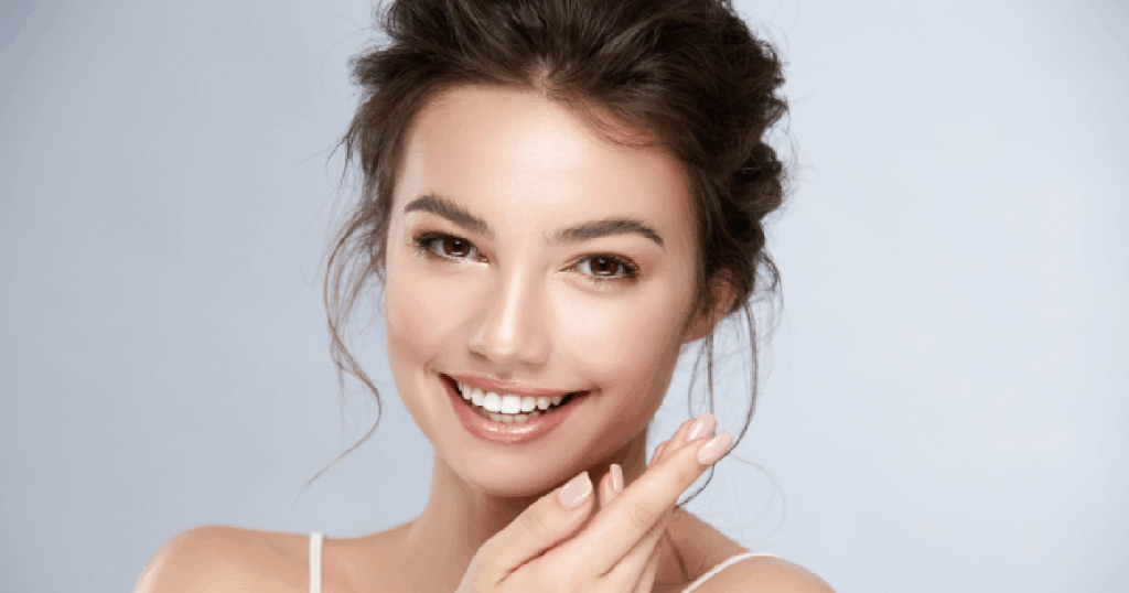 Smiling woman with glowing, radiant skin showcasing the results after AquaGold facial in Humble, TX