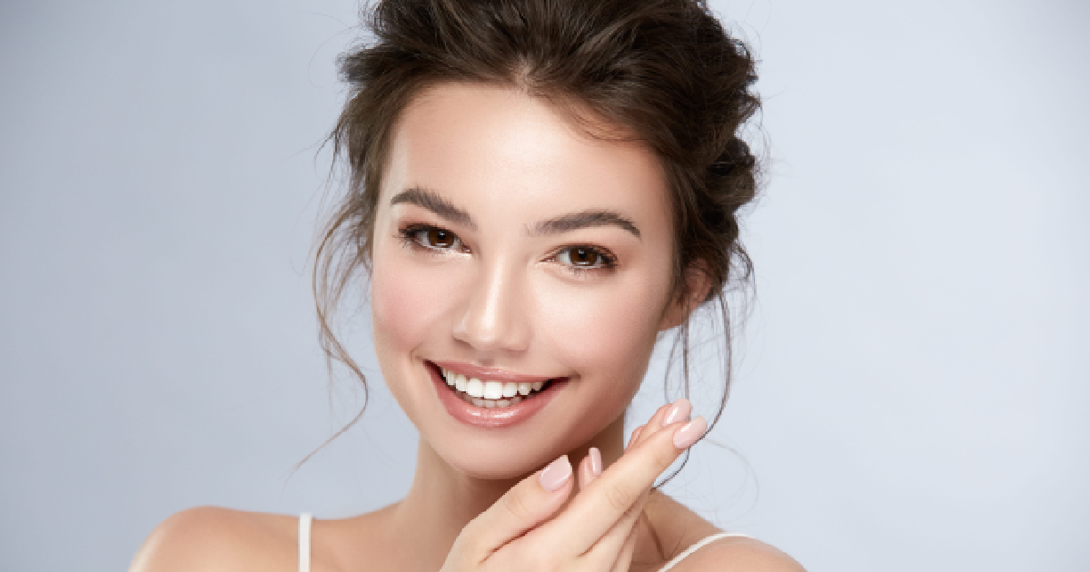 Smiling woman with glowing, radiant skin showcasing the results after AquaGold facial in Humble, TX